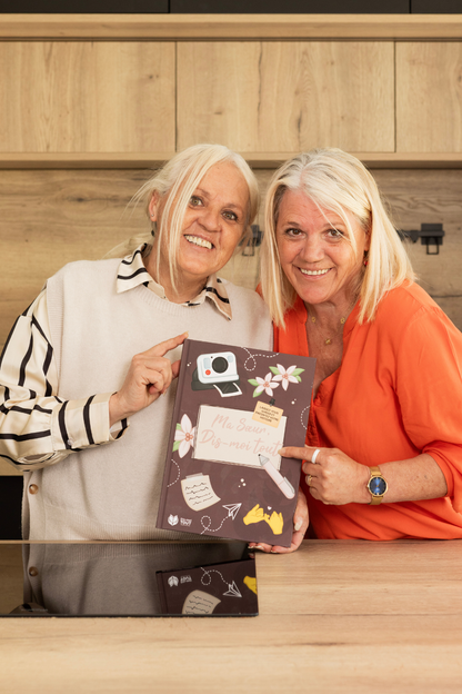 deux femmes souriantes avec le livre Ma soeur, dis-moi tout comme cadeau